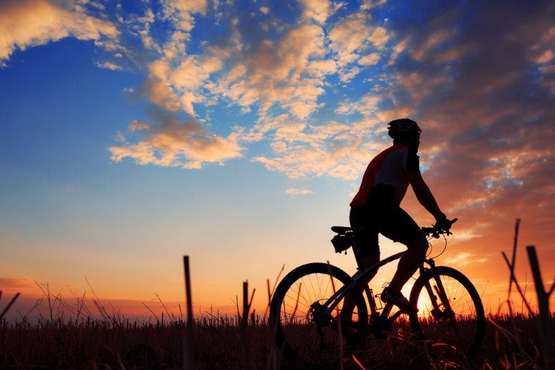 cyclist with sunset in background